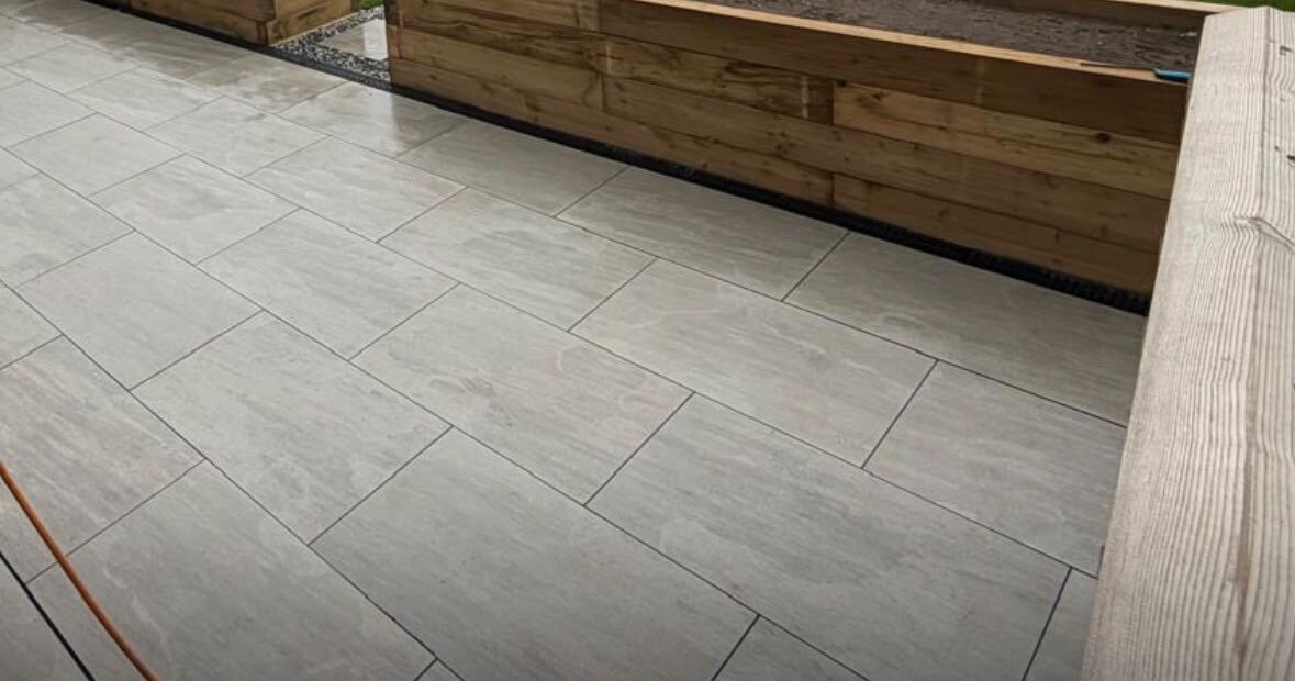 Porcelain patio flags laid beside timber planters